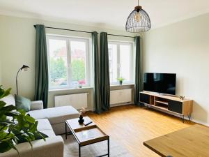 a living room with a couch and a tv at zum Frühling in Schweinfurt