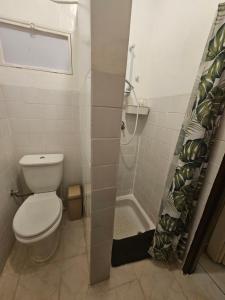a bathroom with a toilet and a shower at Room Vision City 2020 in Kigali