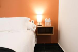 a bedroom with a bed and a lamp on a night stand at Walkable Vacation Gem 2BR1BA Office in Mazatlán +43 photos