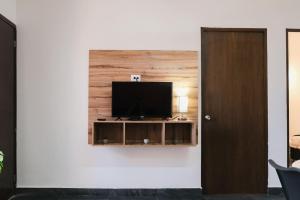 a flat screen tv on a wall in a living room at Walkable Vacation Gem 2BR1BA Office in Mazatlán