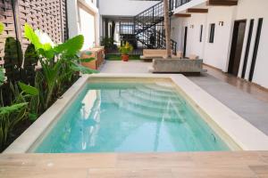 a swimming pool in the middle of a house at Walkable Vacation Gem 2BR1BA Office in Mazatlán