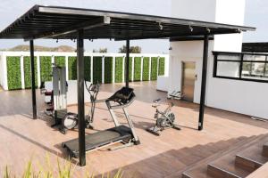 a gym with two exercise bikes under a pavilion at King Bed Retreat Parking Ideal Workspace in Mazatlán