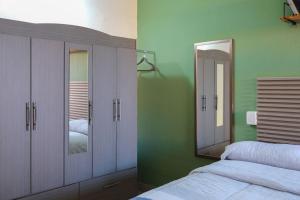 a bedroom with a bed and a mirror at Remodeled Cozy Central 3 blocks from the Malecon in Mazatlán