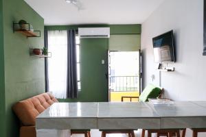 a living room with a table and a couch at Remodeled Cozy Central 3 blocks from the Malecon in Mazatlán