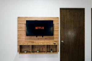a flat screen tv on a wooden wall at 2BR1BA Office No Car Needed in Mazatlán