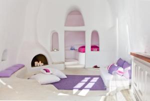 A bed or beds in a room at Perivolas Hotel