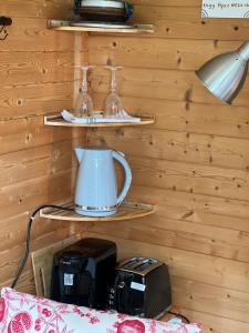 a room with a wall with wooden paneling and a tea kettle at The Cabin in Bradford on Avon