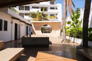 a view of the courtyard of a building with palm trees at Quiet-Central 2BR1BA Relaxed Atmosphere in Mazatlán
