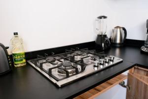a stove top oven sitting on top of a kitchen counter at Relaxed Centrally Located 2BR 1BA Ideal Workspace in Mazatlán