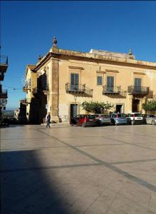 a person walking in front of a large building at B&B Heracleae Luxury Home in Cattolica Eraclea