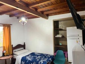 a small bedroom with a bed and a refrigerator at Los Cactus Planta Alta in La Rioja +9 photos
