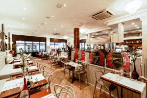 a restaurant with tables and chairs and a bar at Boutique Hôtel Edmond's in Cap d'Ail