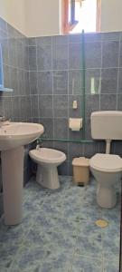 a bathroom with two sinks and two toilets at Aleko Guesthouse in Përmet +30 photos