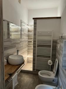 a bathroom with a white toilet and a sink at Affittacamere Dentro Le Mura in Ripa +17 photos