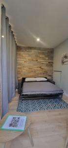 a bedroom with a bed and a wooden wall at L'Escale CDG aéroport, Stade de France, Parc des Exposition, PARIS in Villepinte