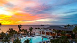 a view of the pool at the resort at sunset at Van der Valk Plaza Beach & Dive Resort Bonaire - ALL INCLUSIVE in Kralendijk