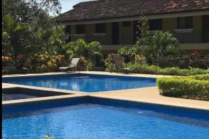 a swimming pool in front of a house at Sweet Dreams #4 in Coco