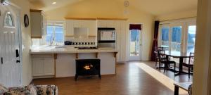 a kitchen with a fireplace in the middle of a room at Sunny Island Cliff Side Views in Anacortes