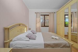 a bedroom with a bed with two books on it at Holiday Home Katharina in Labin +11 photos