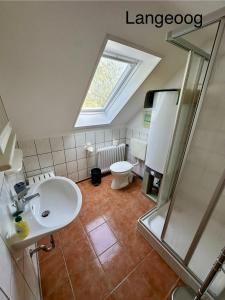 a bathroom with a sink and a shower and a toilet at Haus Tunix in Butjadingen +119 photos