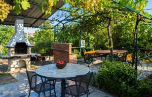a patio with a table and a fire place at Holiday Home Katharina in Labin