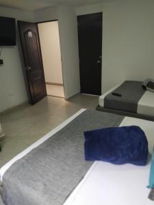 Postel nebo postele na pokoji v ubytování Hotel Palo Alto Laureles