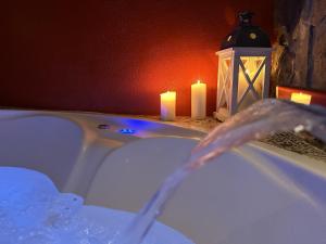 a bathroom with a tub with candles and a lantern at LOFT CHOCOLATE - BENAOCAZ in Benaocaz