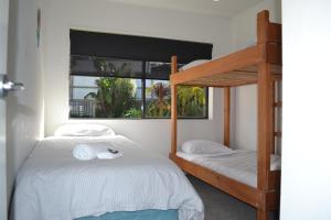 a bedroom with two bunk beds and a window at Aqua Soleil Villas in Whitianga +17 photos