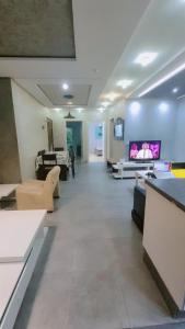 a large living room with couches and a television at Appartement meublé harhora in El Harhoura