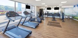 a gym with treadmills and cardio equipment in a building at NH Collection Villa de Bilbao in Bilbao