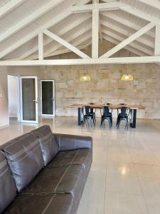 Una sala de estar con un sofá, una mesa y sillas. en Tobiano Tempo, en Esquel