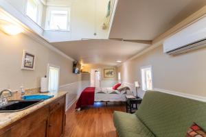 a kitchen with a sink and a bed in a room at Little Red Caboose in Oakhurst
