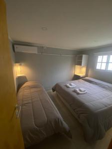 a small bedroom with a bed and a window at Alquiler temporario Ruta 3 in Azul