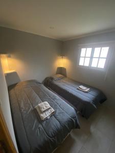 a bedroom with two beds and a window at Alquiler temporario Ruta 3 in Azul
