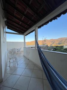 a hammock on a balcony with a view of the desert at República Os Bartira in Ouro Preto