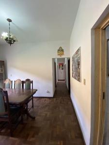 a dining room with a table and chairs and a hallway at República Os Bartira in Ouro Preto
