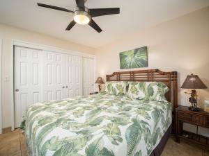 a bedroom with a bed and a ceiling fan at WBH D116 Aloha Wai - Garden Suite Just Steps from the Sea in Kihei +22 photos