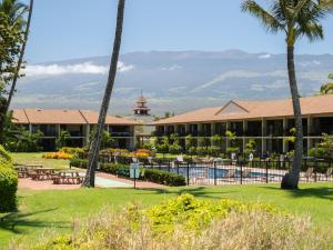a view of the resort with palm trees at WBH D116 Aloha Wai - Garden Suite Just Steps from the Sea in Kihei