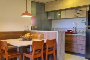 a kitchen with a table with a bowl of fruit on it at Vista espetacular em Itacimirim in Itacimirim