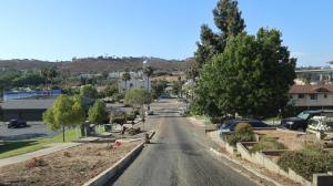 an empty street in a small town with trees at Xlnc Exotic Home Gillespie Drive in Spring Valley
