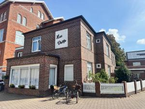 a brick building with two bikes parked in front of it at Haus Deitje in Borkum