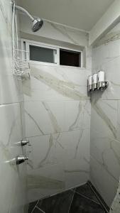 bagno con pareti in marmo bianco e finestra di Casa los Arcos Oaxaca a Città di Oaxaca