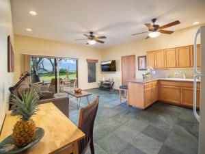 a kitchen and living room with a pineapple on a table at Aloha Aku Bamboo Suite - Discover Beachfront Serenity in Kihei