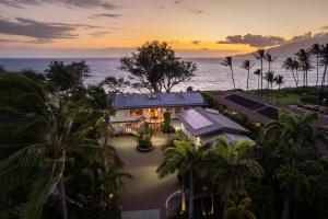 an aerial view of a house with palm trees and the ocean at Aloha Aku Bamboo Suite - Discover Beachfront Serenity in Kihei