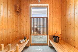 an empty room with a window in a wooden room at Ferienhaus Saltkrokan Olpenitz in Olpenitz