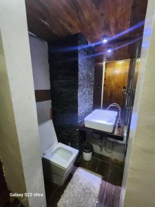 a bathroom with a toilet and a sink at 1BR Northpoint Condo Free Airport pick up for 3 nights stay or more in Cabaguio +6 photos