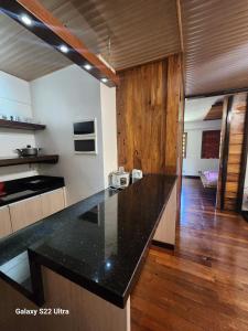 a kitchen with a black counter top in a room at 1BR Northpoint Condo Free Airport pick up for 3 nights stay or more in Cabaguio