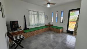 a living room with a bench with a window at Casa de praia in Buzios
