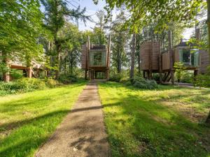 a tree house in the middle of a grassy field at Rooftop Views & Private Sauna in Antoing