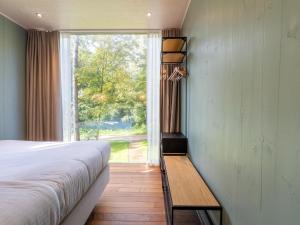a bedroom with a bed and a large window at Stylish Stay with Sauna in Antoing +32 photos